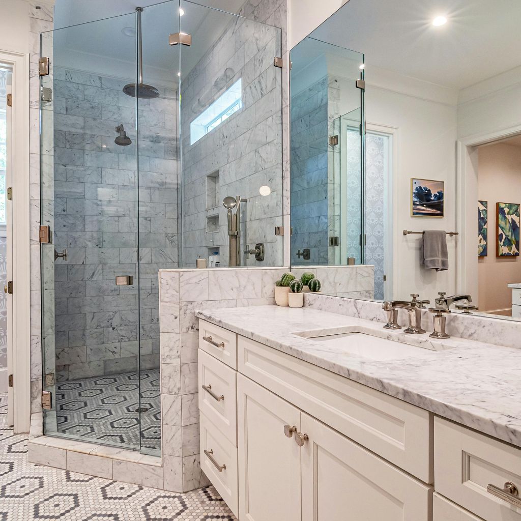 Walk in shower and double vanity with custom tile and marble countertop installation